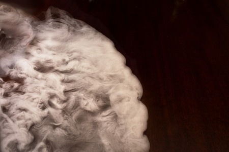 White smoke and steam swirl on an old tableの写真素材