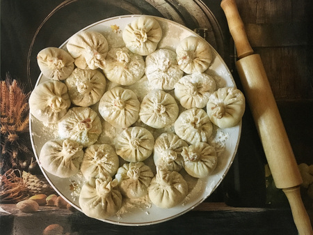 Ravioli and Russian dumplings from flour, meat and spices with rolling pinの写真素材