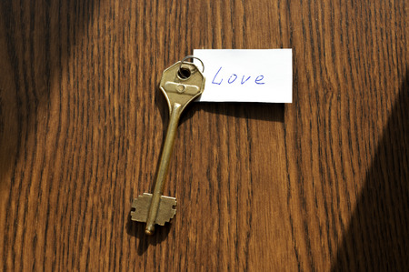 The key to love of bronze color on a wooden backgroundの写真素材
