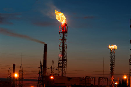 Fire from the factory's pipe, gas and oil production, sunset viewの写真素材