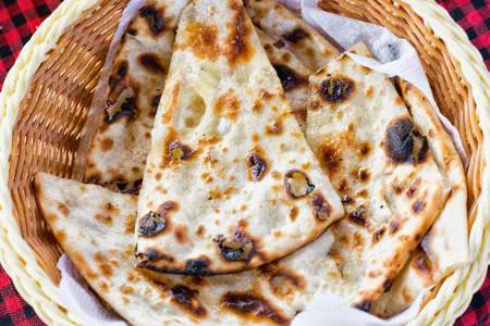 tortillas in a plate on a checkered tablecloth. India