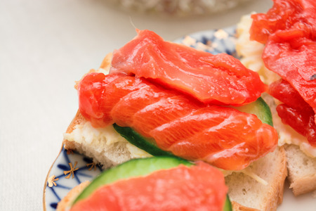 Sandwich with salmon and cucumber on a plate, selective focusの写真素材