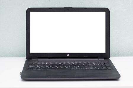 Front view of the laptop is on the work table, colorful background, clipping path inside.