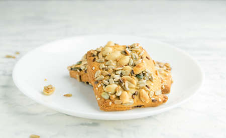 Homemade cookies with cereals and nuts on a marble table.の写真素材