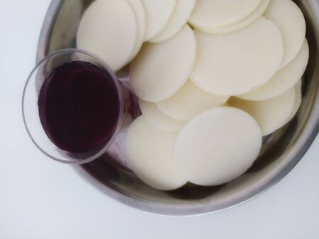 Glass of wine and unleavened bread for holy communionの写真素材