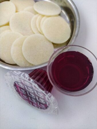 Cups and glass of wine, unleavened bread for holy communionの写真素材