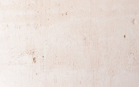 Stucco Wall Background. Close-up of beige gypsum plaster on the wall. The concept of building and repairing a house. background.の写真素材