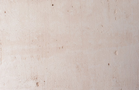 Stucco Wall Background. Close-up of beige gypsum plaster on the wall. The concept of building and repairing a house. background.の写真素材