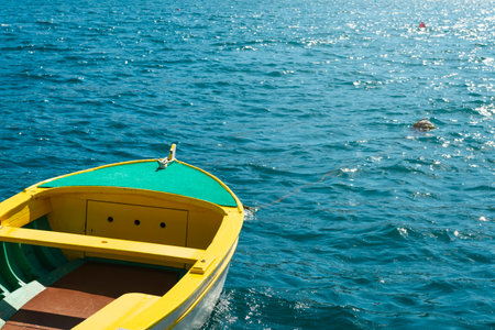 Yellow fishing boat on the background of the turquoise seaの写真素材