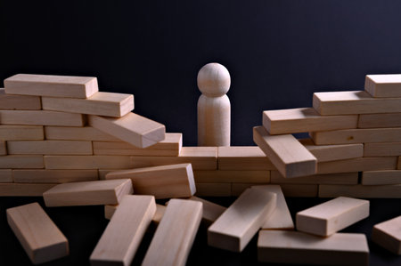 A wooden figure faces a disordered stack of blocks, creating a visual representation of...