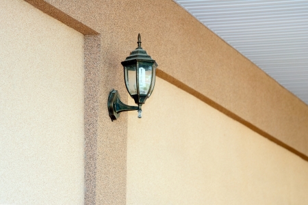 Old-time lamp on light wallの写真素材