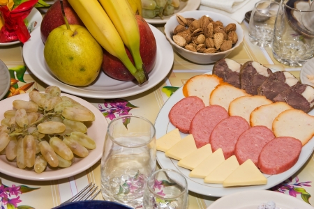 Snack and fruits on eaten tableの写真素材