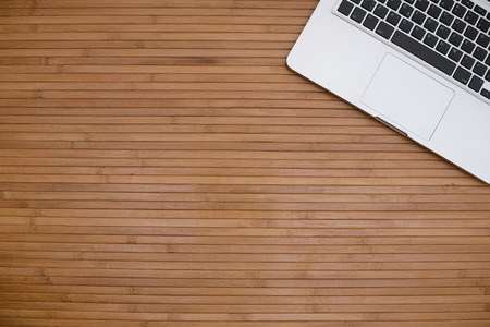 Workspace. Laptop on dark wooden table, minimalistの写真素材