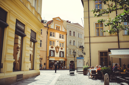 PRAGUE, CZECH REPUBLIC - JUNE 2016: cozy and beautiful tourist street of the Prague's old architecture and people walking, street cafes.のeditorial素材
