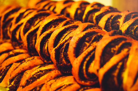 golden pies with poppy close-up, poppy bun warm home color.の写真素材