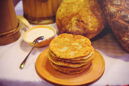 pile of air pancakes on a wooden dinette, a traditional food family. pancakes of golden color, sour...