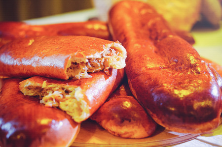 golden pies with cabbage, pie split in half, home kitchen.の写真素材