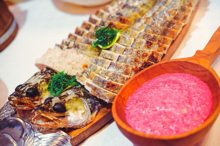 stuffed fish, serving on a ditch with red horseradish in wooden dishes, traditional home cooking.