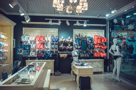 interior of a colorful modern underwear shop. Female mannequin in panties and bras and stands in a shopping center. Cozy light. Customer purchases, soft tone.の写真素材