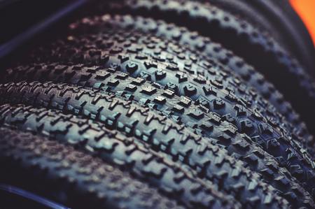 The tires on the bicycle wheel are in a row. selling a piece of mountain bike tires in closeup.