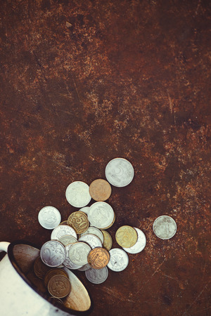 the fall of the Russian ruble, poverty and poverty scattered coins in the old circle on a rusty background, sanctions and the collapse of the economy.の写真素材