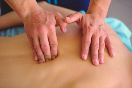 therapeutic back massage, drainage, training and practice, hands doing back massage.の写真素材
