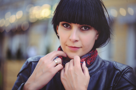 happy brunette woman outdoors in the city.の写真素材