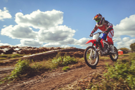 Woman on enduro motocross in motion, desire for victory, dynamics of speed.の写真素材