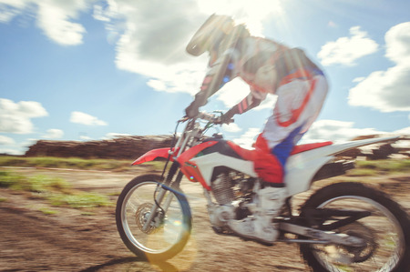 Woman on enduro motocross in motion, desire for victory, dynamics of speed.