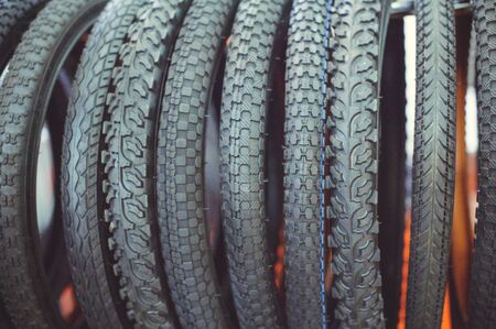 Bicycle tires in a assortment of a store in a row close-up.
