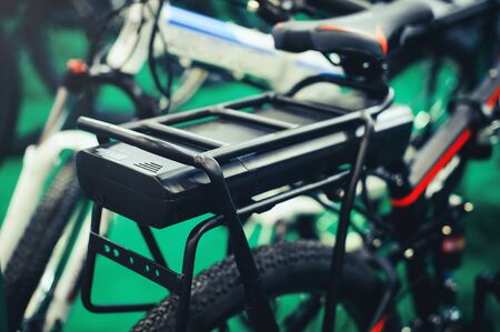 On the trunk is an electric bicycle battery, environmentally friendly technology. service and maintenanceの写真素材