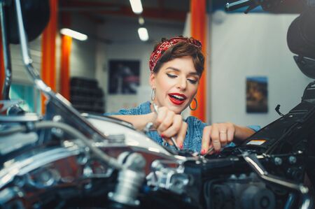 Beautiful motorcycle repair in the style of pin-up, service and sale. Women's Equality Professionの写真素材