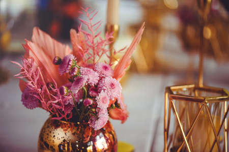 Luxurious floral arrangement of pink and white flowers in glass vases on a white table, copy space. Wedding decorations, holiday conceptの写真素材