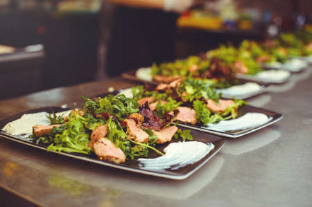 meat salad in the restaurant kitchen, the dish is ready for serving to the client.