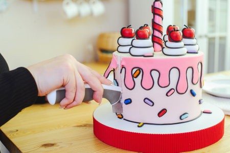 beautiful cake made in a cartoon style with a candle and cherries in a bright, close-up section
