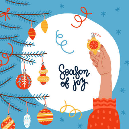 Merry Christmas and Happy New Year Greeting card. Young women hand decorating Christmas tree with elegant glass bauble. Winter holidays banner with Fir branches. Lettering quote Season of joy.のイラスト素材