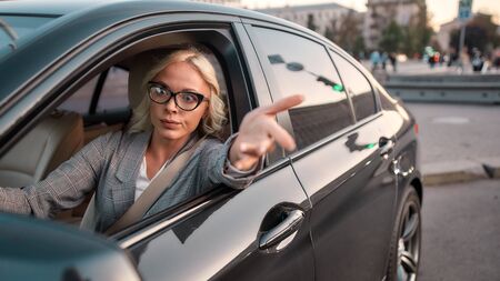 Feeling angry. Portrait of angry business woman gesturing with hands and arguing with somebody while...