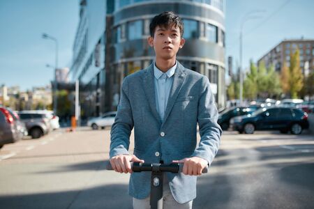 Fast and convenient. Use of scooter as a means of transportation on the streetの写真素材