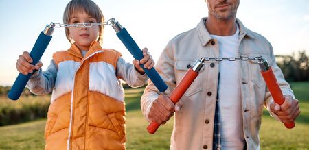 Toys for boys. Cheerful family spending time in the park on a sunny dayの写真素材
