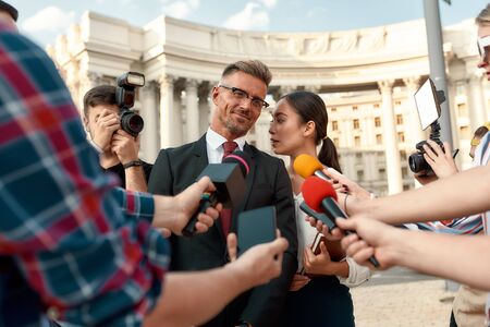 Journalists conducting interview of politician. Journalism industry, live streaming concept.の写真素材
