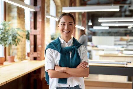 Be Professional. Confident asian office worker posing indoorsの写真素材
