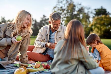 Funny moments. Happy family spending time in the park on a sunny dayの写真素材