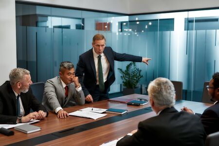 Get out of here right now. Angry mature businessman in formal wear asking employee to leave business...