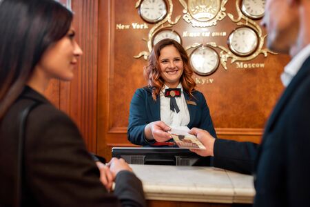 Meeting your highest expectations. Portrait of happy couple checking-in at the hotel. Man is...