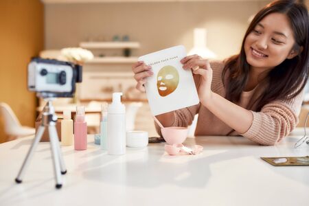 Not just an activity, investment. Young female blogger recording a tutorial video for her beauty...