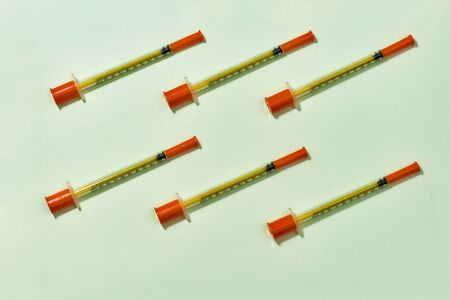 Top view of insulin syringes for diabetes lying diagonally isolated over light background. Injection medicine conceptの写真素材