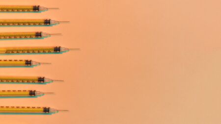 Top view of medical syringes for injections lying isolated over light background. Injection medicine conceptの写真素材