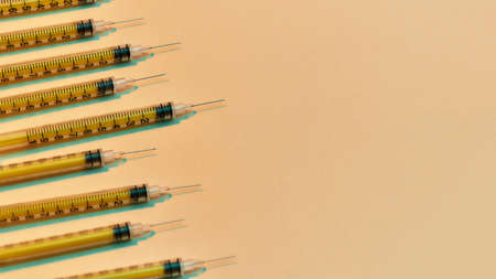 Close up of medical syringes for injections lying isolated over light background. Injection medicine...