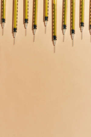 Top view of medical syringes for injections lying isolated over light background. Injection medicine conceptの写真素材