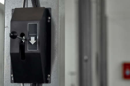 Close up of hoist up and down switch button in car garage. Car service, repair, maintenance conceptの写真素材